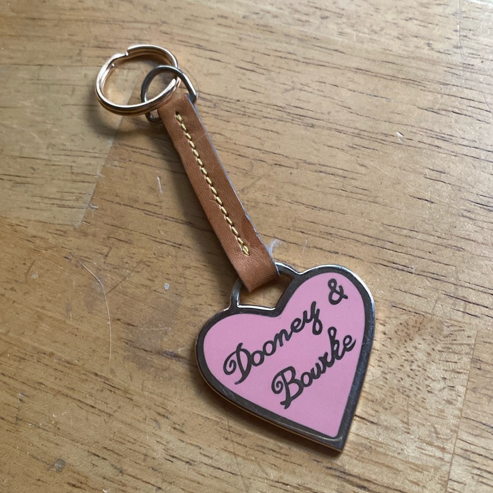 Dooney & Bourke bag charm tan gold color in very good condition